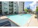 Swimming pool and sun deck with several lounge chairs, trees, and nearby residences at 1074 Peachtree Ne Walk # B404, Atlanta, GA 30309