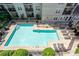 An overhead view of a bright blue community swimming pool and lounge area at 1074 Peachtree Ne Walk # B404, Atlanta, GA 30309