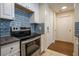 Kitchen with oven, stove, and white cabinets with backsplash at 1074 Peachtree Ne Walk # B404, Atlanta, GA 30309