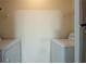 Dedicated laundry room with side-by-side washer and dryer units and shelving at 1074 Peachtree Ne Walk # B404, Atlanta, GA 30309