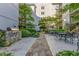 Charming outdoor space with stone grill area, seating, and lush landscaping at 1074 Peachtree Ne Walk # B404, Atlanta, GA 30309