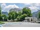 Street-level view showcasing the building's entrance and surrounding landscape at 1074 Peachtree Ne Walk # B404, Atlanta, GA 30309