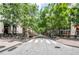 An urban street view lined with mature trees, restaurants and boutique shops at 1074 Peachtree Ne Walk # B404, Atlanta, GA 30309