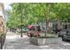 A sidewalk and street with mature trees, planters, restaurants and boutique shops at 1074 Peachtree Ne Walk # B404, Atlanta, GA 30309