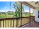 Covered porch with wood railings offers beautiful views of the lush, green backyard and beyond at 122 Gingers Way, Mcdonough, GA 30252