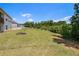 Wide backyard view with a large grassy area and perimeter of trees; backs to wooded area for privacy at 122 Gingers Way, Mcdonough, GA 30252