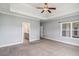 Large primary bedroom with tray ceiling, ensuite bathroom, and plush carpet at 122 Gingers Way, Mcdonough, GA 30252
