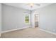 Bright, carpeted bedroom with window and ensuite bathroom at 122 Gingers Way, Mcdonough, GA 30252