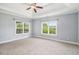Expansive bedroom with tray ceilings, plush carpeting, and view to the backyard at 122 Gingers Way, Mcdonough, GA 30252
