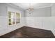Dining room featuring hardwood floors, wainscoting, and a modern chandelier at 122 Gingers Way, Mcdonough, GA 30252