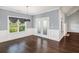 Dining area with hardwood floors, wainscoting, and French doors leading to the outside at 122 Gingers Way, Mcdonough, GA 30252