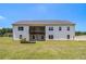 Rear exterior view of a two-story home with a spacious backyard and covered patio; great for entertaining at 122 Gingers Way, Mcdonough, GA 30252