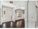 Elegant foyer with dark hardwood floors, white trim, and a view into adjacent room at 122 Gingers Way, Mcdonough, GA 30252