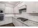 Modern kitchen features granite counters, subway tile backsplash, and stainless appliances at 122 Gingers Way, Mcdonough, GA 30252