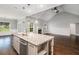 Bright kitchen featuring granite countertops, stainless appliances, and view to the living area at 122 Gingers Way, Mcdonough, GA 30252