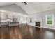 Open-concept living room and kitchen features a cozy fireplace and hardwood floors at 122 Gingers Way, Mcdonough, GA 30252