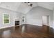 Spacious living room with a fireplace, hardwood floors, and large windows at 122 Gingers Way, Mcdonough, GA 30252