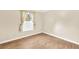 Bedroom featuring wood floors, a large window with curtains, and neutral paint at 1482 N Crossing Ne Cir, Atlanta, GA 30329