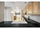 View of kitchen with wood cabinets, black counters, and a view to the breakfast nook at 1482 N Crossing Ne Cir, Atlanta, GA 30329