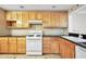 Bright kitchen with wooden cabinets, black countertops, and tile floors at 1482 N Crossing Ne Cir, Atlanta, GA 30329