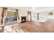 Bright living room featuring a fireplace, wood floors, and sliding glass doors to the deck at 1482 N Crossing Ne Cir, Atlanta, GA 30329