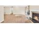 Spacious living room featuring wood floors, a fireplace, and access to an outdoor patio at 1482 N Crossing Ne Cir, Atlanta, GA 30329