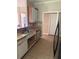 Kitchen featuring tile floors, granite countertops, stainless steel dishwasher, and wooden cabinets at 21 Spring Folly Nw, Cartersville, GA 30121