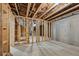 Unfinished basement with concrete flooring and exposed wood beams at 3111 Stonegate Sw Dr, Atlanta, GA 30331