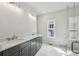 Bathroom with double sink vanity, marble floors, and glass shower at 3111 Stonegate Sw Dr, Atlanta, GA 30331