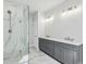 Bathroom featuring a glass shower, double sink vanity, and marble floors at 3111 Stonegate Sw Dr, Atlanta, GA 30331