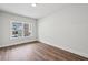 Bright bedroom features wood floors, base trim and a large window at 3111 Stonegate Sw Dr, Atlanta, GA 30331