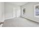 This carpeted bedroom features two windows offering natural light and neutral paint at 3111 Stonegate Sw Dr, Atlanta, GA 30331