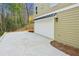 Spacious two-car garage with ample parking on a concrete driveway and stylish exterior lighting at 3111 Stonegate Sw Dr, Atlanta, GA 30331