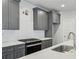 Modern kitchen features sleek gray cabinets, white countertops, and stainless steel appliances at 3111 Stonegate Sw Dr, Atlanta, GA 30331