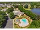 Aerial view of a clubhouse, pools, and lush landscaping in a residential community at 40 Wimberly Way, Covington, GA 30016