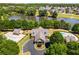Aerial view of a well-maintained clubhouse, community pool, and landscaping near a tranquil lake at 40 Wimberly Way, Covington, GA 30016