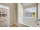 Bathroom featuring a soaking tub with tile surround and a separate shower enclosure at 40 Wimberly Way, Covington, GA 30016