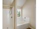 Well-lit bathroom featuring a combination tub and shower with sleek fixtures and finishes at 40 Wimberly Way, Covington, GA 30016
