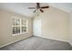 Cozy bedroom featuring a ceiling fan, a window for natural light, and ample closet space at 40 Wimberly Way, Covington, GA 30016