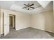 Large bedroom featuring neutral decor, plush carpet, and a tray ceiling with fan at 40 Wimberly Way, Covington, GA 30016