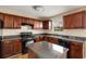 Well-equipped kitchen featuring granite countertops and black appliances at 40 Wimberly Way, Covington, GA 30016
