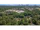 An aerial view showing houses nestled among dense trees, nearby shops, and the Atlanta skyline at 962 Cardova Ne Dr, Atlanta, GA 30324