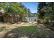 Large backyard featuring an outdoor fire pit, patio, privacy fence, mature trees, and a lush lawn at 962 Cardova Ne Dr, Atlanta, GA 30324
