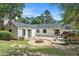 Beautiful backyard featuring a stone fire pit, brick patio, and well-maintained landscaping at 962 Cardova Ne Dr, Atlanta, GA 30324