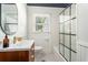 Bright bathroom with black and white tile, a modern vanity, updated fixtures, and shower-tub combination at 962 Cardova Ne Dr, Atlanta, GA 30324
