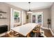 Dining room with white table and wood chairs, neutral walls, and double doors to outside at 962 Cardova Ne Dr, Atlanta, GA 30324