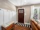 Cozy entryway featuring coat hooks, wood floors, and a classic paneled front door at 962 Cardova Ne Dr, Atlanta, GA 30324
