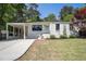 Charming home featuring a well-manicured lawn, covered car port, and freshly painted exterior at 962 Cardova Ne Dr, Atlanta, GA 30324