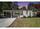 Charming home featuring a well-manicured lawn, covered car port, and freshly painted exterior at 962 Cardova Ne Dr, Atlanta, GA 30324