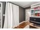 Home office featuring hardwood floors, neutral walls, custom bookshelves, and a light-blocking curtain at 962 Cardova Ne Dr, Atlanta, GA 30324